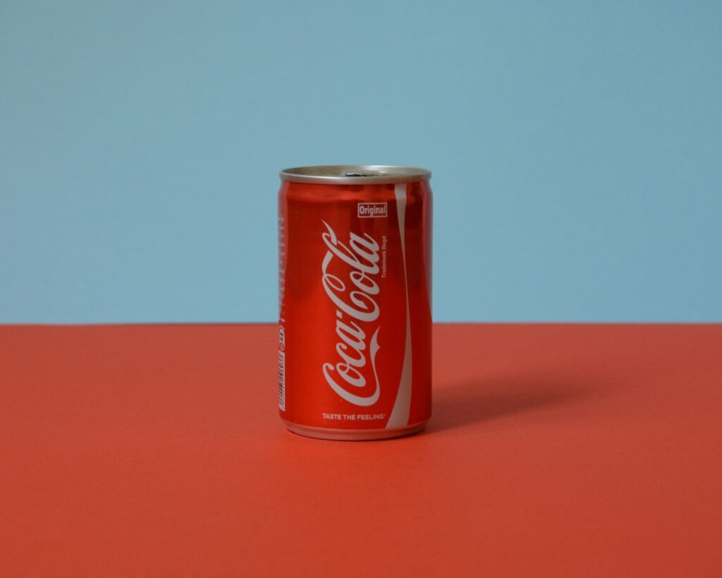 coca cola can on red table