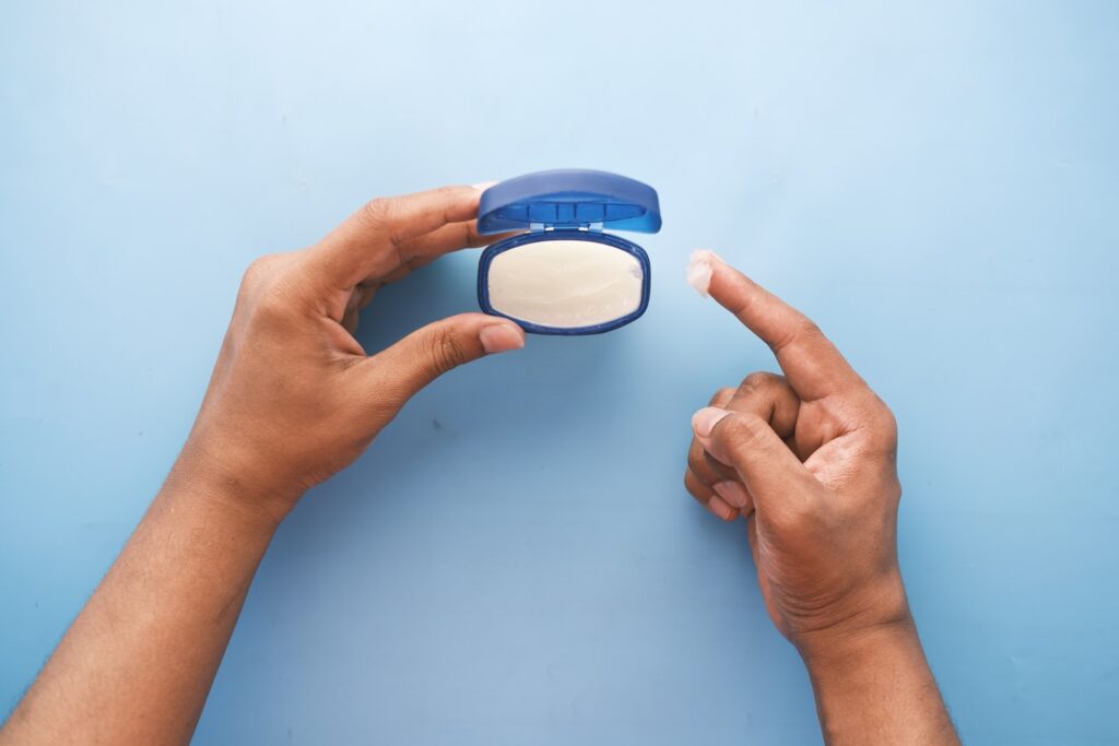 person holding blue round container