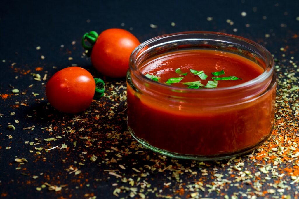 Tomato and tomato puree with parsley in bowl