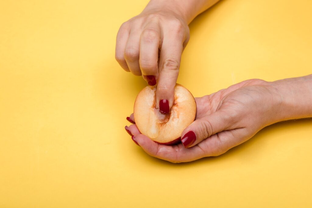 person holding red apple fruit