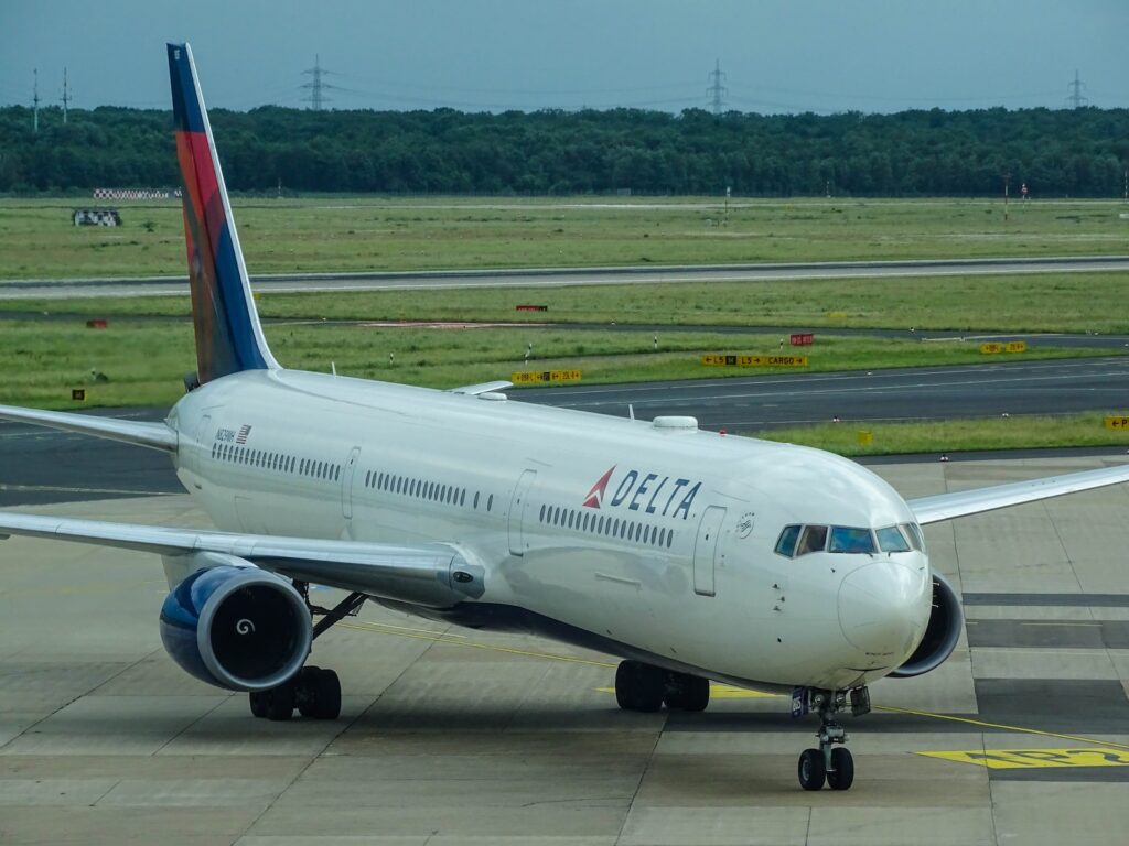 white Delta airplane on airport