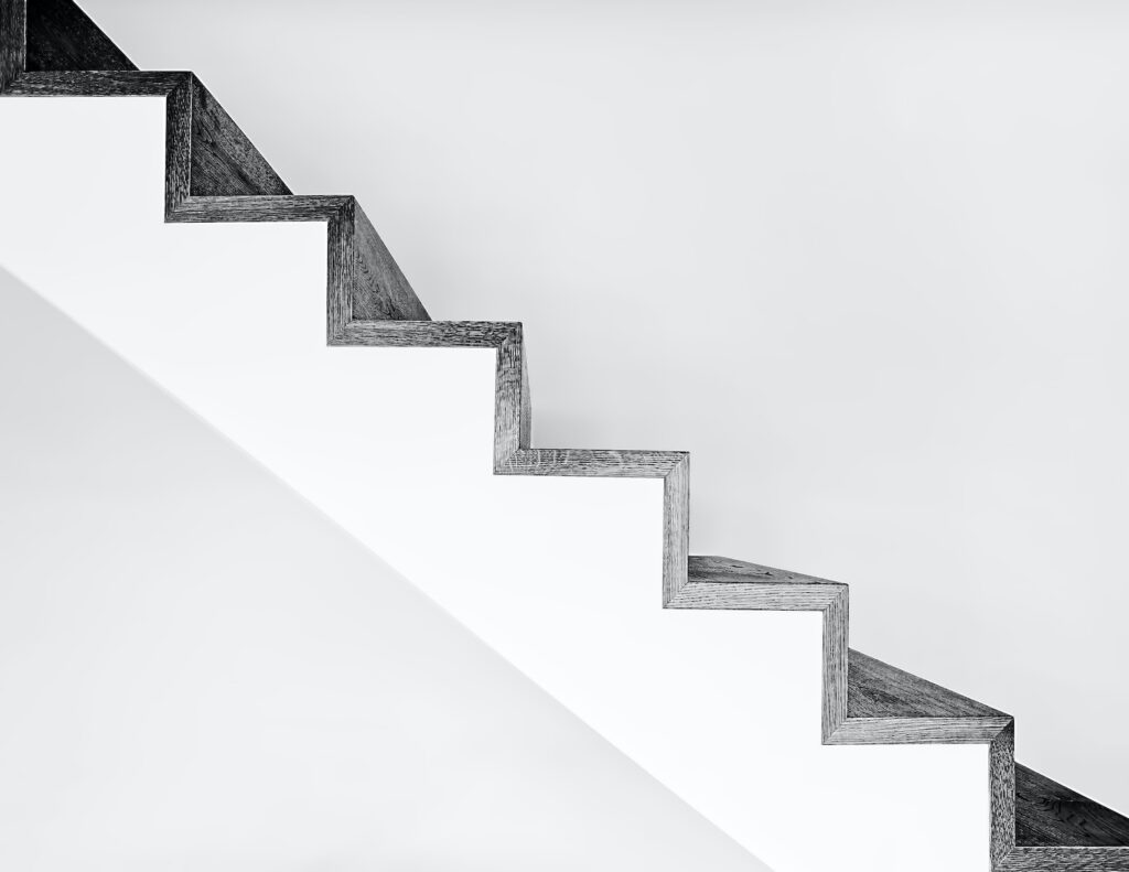 white concrete stairs with black metal railings