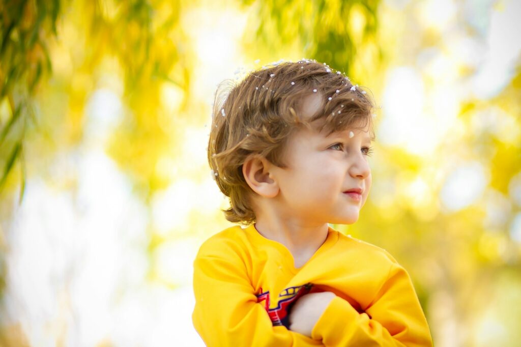 girl in yellow hoodie standing during daytime