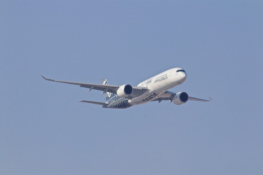 white airplane taking off during daytime