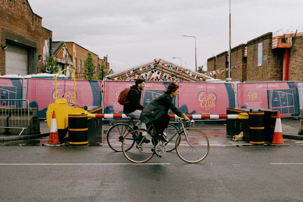 a couple of people riding bikes down a street