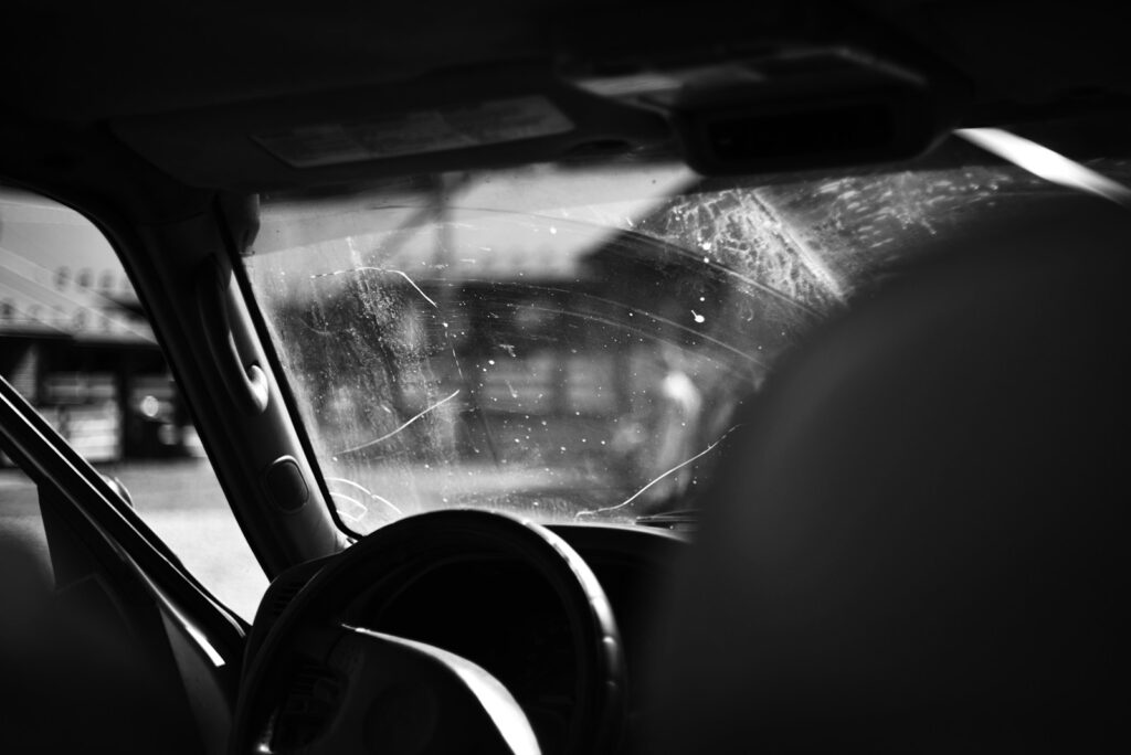 A black and white photo of the inside of a car